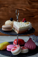 Cakes on a dark slate bunk stand. Desserts. Sweet table