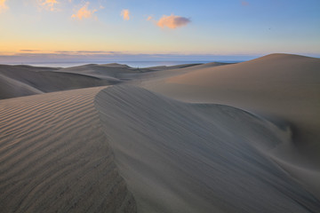 Fototapeta na wymiar Small lonely runner on big dunes in Maspalomas, Gran Canaria island.