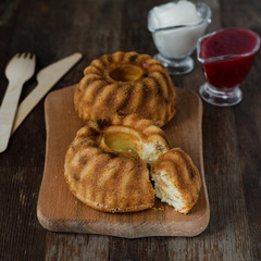 Cottage cheese casserole with raisins and semolina on wooden background.