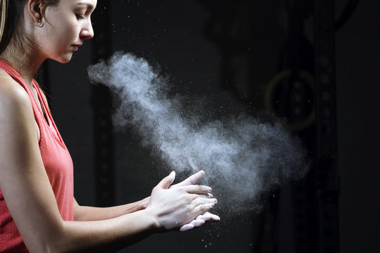 Woman clapping hands with chalk