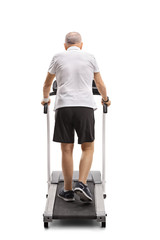Fototapeta na wymiar Mature man walking on a treadmill