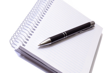 Pen and notepad on white background