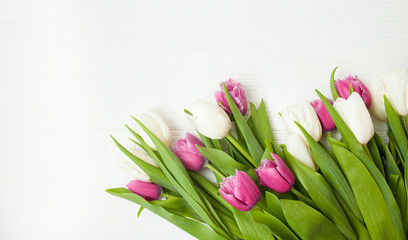 Fresh tulips on a white wooden background for Mother's Day