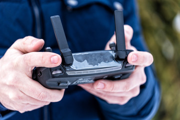 Hands of a man holding a remote control from a quadrocopter