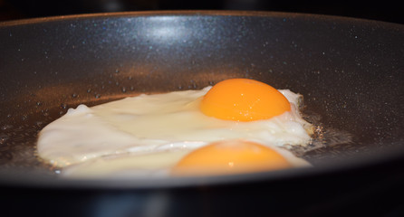Two fried eggs in a pan, sunny side up fried eggs for breakfast