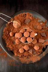 Chocolate truffles covered with cacao in a ceramic cup