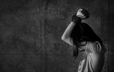 Asian girl with his hands tied in an abandoned building,stop abusing violence,human trafficking...