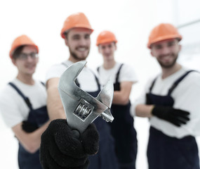 closeup. the wrench in the hands of the builders