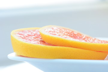 Obraz na płótnie Canvas Two grapefruit slices