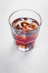 Whiskey with ice in glasses, rustic wood background, copy space