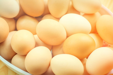 white and brown fresh chicken eggs in a plate. concept of easter. cooking ingredients