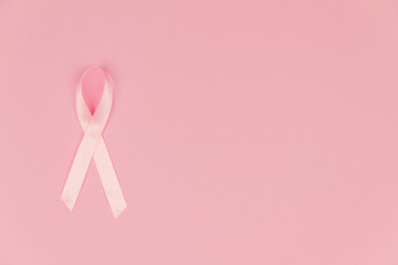 Pink tape as symbol of women illness mammary cancer isolated on pink background