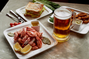 Beer snack in the pub or bar. Beer, shrimps and nuts.