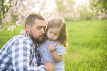 father and child walking on sunset