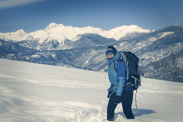 Fototapeta na wymiar A Hiker trekking in winter landscape.
