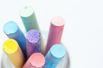 Bunch of Multicolored Chalks Crayons in Pencil Cup. Top View White Background. Education Arts Crafts Creativity Concept. Elegant Minimalist Style. Website Poster Streamer Banner Template. Copy Space