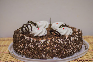 festive cherry cake with cream and shavings of chocolate