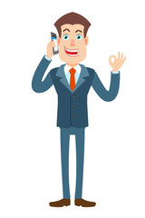 Businessman talking on mobile phone and showing a okay hand sign