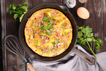 cooking omelette with bacon and herbs