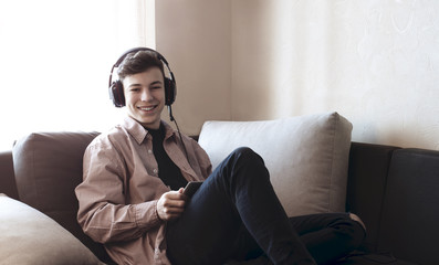 Obraz premium teenager in headphones listening to music