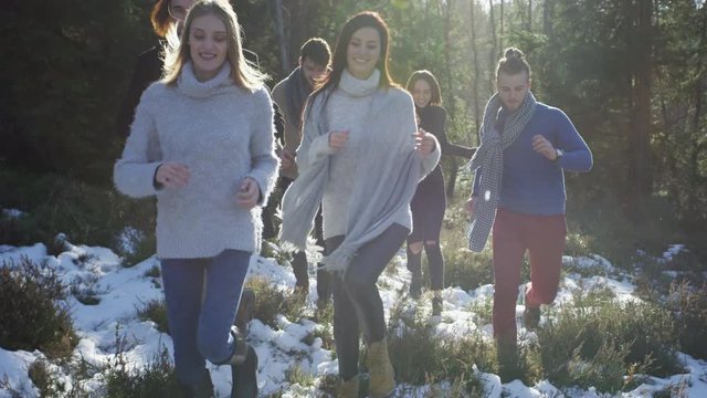 Young men and women running during winter