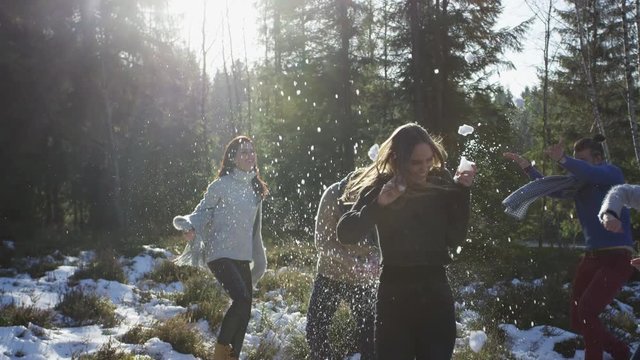 Playing with snow in the forest