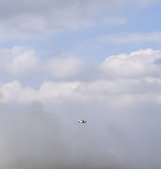 An agricultural plane flies over a field of rice. Air application of herbicides