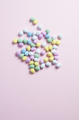 pastel colored easter eggs on a pink background