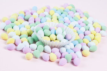 pastel colored easter eggs on a pink background