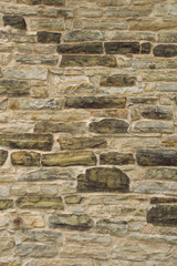 Old rough stone wall with grout