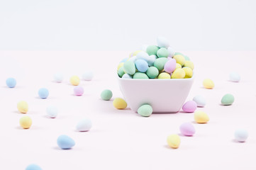 colorful candy eggs in a white bowl