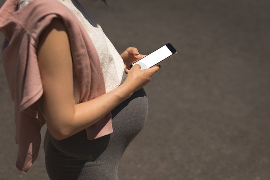 Pregnant woman using mobile phone