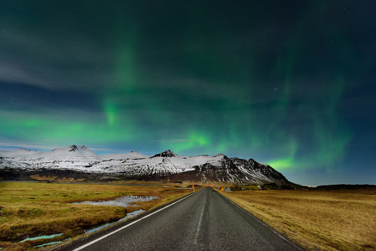 The Northern Light at the mountain in Iceland. Landscape with green bands of Aurora Borealis. Nightscape magical.