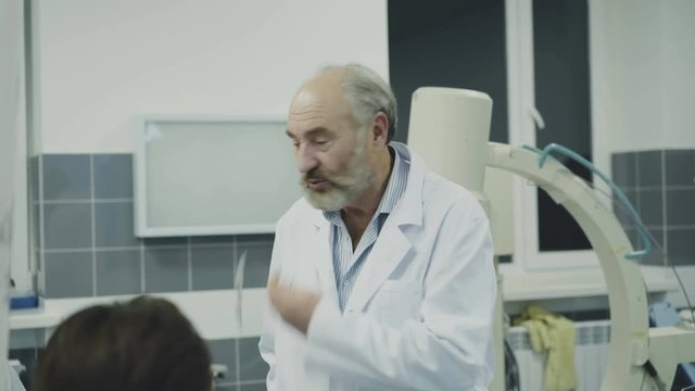 Doctors takling with co-worker on break in the rest room. 4K