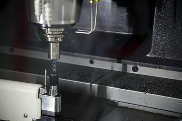 CNC milling machine measuring tool length offset by automatic tool measurement.