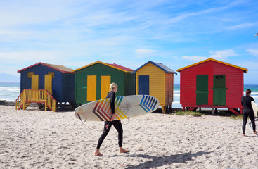 MUIZENBERG BEACH, CAPE TOWN, SOUTH AFRICA - 9 March 2018 : Muizenberg beach is a common morning surf spot for Capetonians. - obrazy, fototapety, plakaty