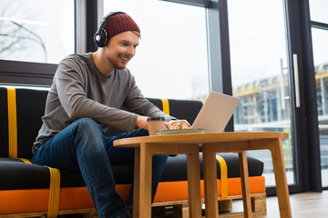 Positive cheerful man working as a freelancer