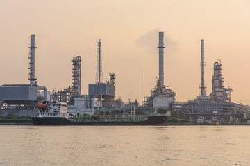 Fototapeta premium Oil refinery at the river in sunrise time / Big Factory in sunrise time