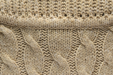 Texture of a Knitted Sweater. Area Abutting the Collar to a Sweater with Cable Knitted Pattern. Blank Background