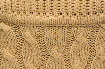 Texture of a Beige Color Knitted Sweater. Area Abutting the Collar to a Sweater with Cable Knitted Pattern. Blank Background