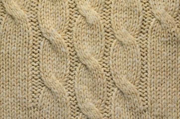 Knit Texture of Beige Wool Knitted Fabric with Cable Knits Pattern. Blank Background
