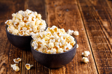 Two exquisite ceramic bowls with fresh popcorn.