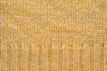 Texture of a Orange Color Knitted Sweater with Two Types of Knitting. Knit texture as background.