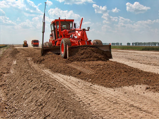 Obraz premium Grader adjust elevation level soil for construction site