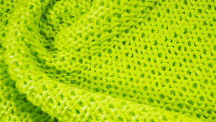 Beautiful knitted background of green yarn.