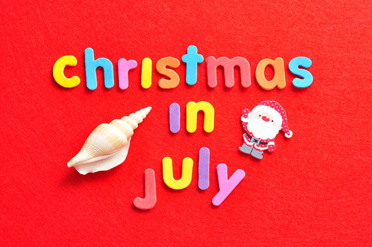 Christmas in July on a red background with a shell and a Santa Clause figure