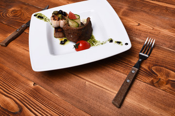 Dish with modern presentation on square plate.