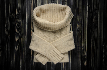 Sweater with a Large Throat on a Wooden Table, Top View. Kntt Clotges Background