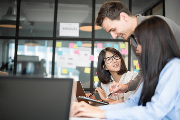 Business people are discussing about their work. Happy boss is talking to employee at workplace. Setup studio shooting.