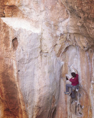 Rock-climbing in Turkey. The climber climbs on the route. Photo from the top.